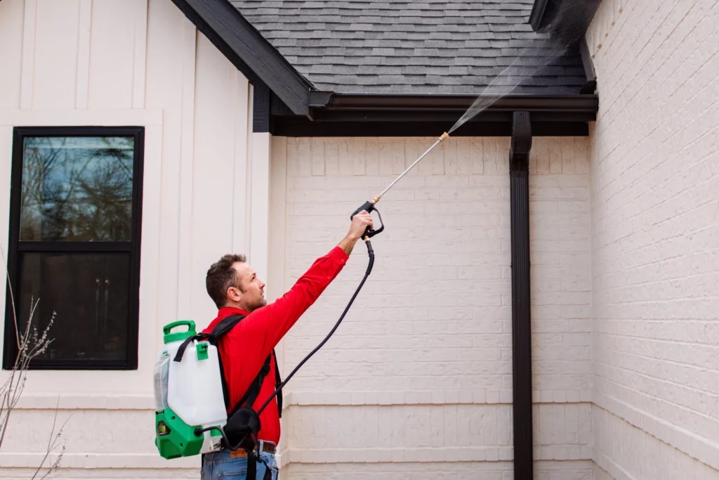 Technician performing pest control service